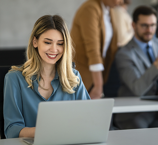 women smiling at a laptop