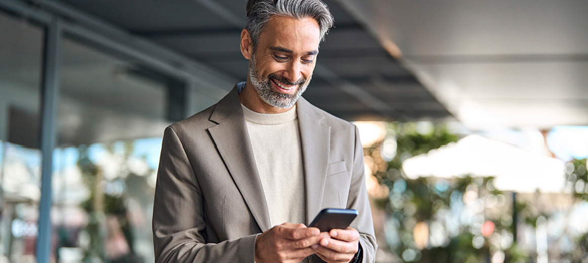 business man smiling with his phone