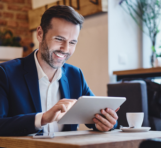 man smiling while working on a tablet