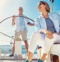 women and a man on a sailboat