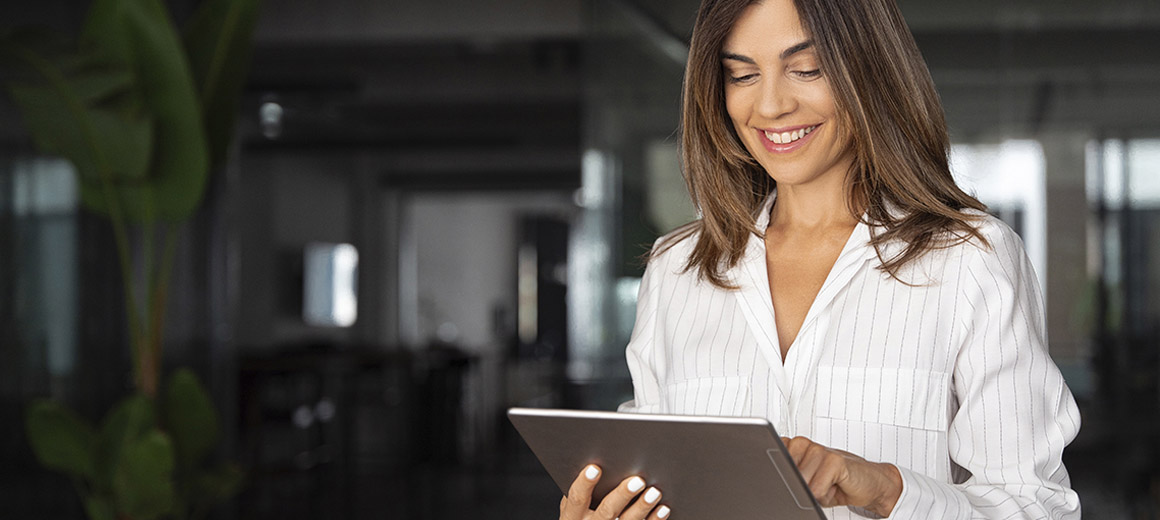 women smiling while working on a tablet