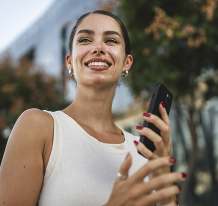 women smiling with a phone