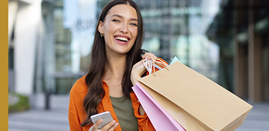 women smiling with shopping bags