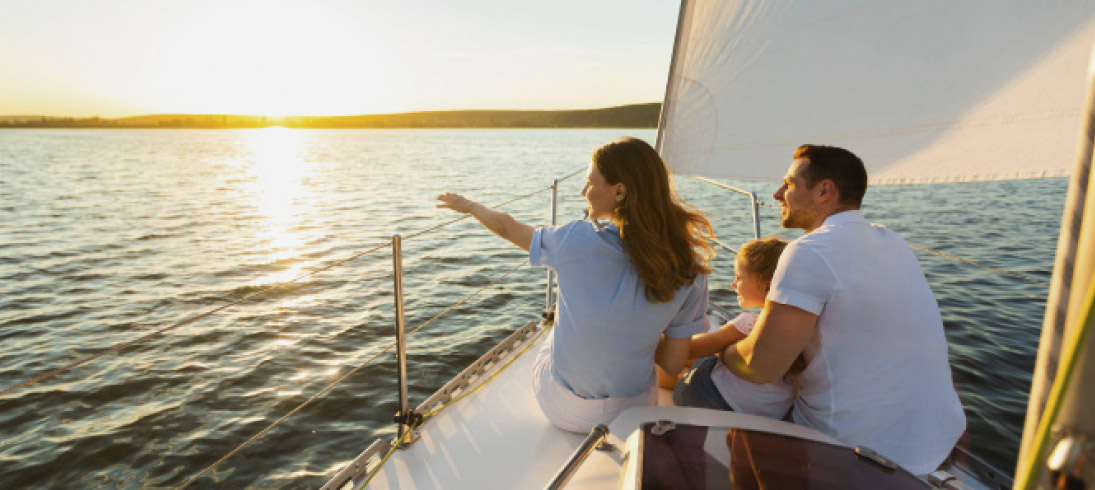 young family on a sailboat
