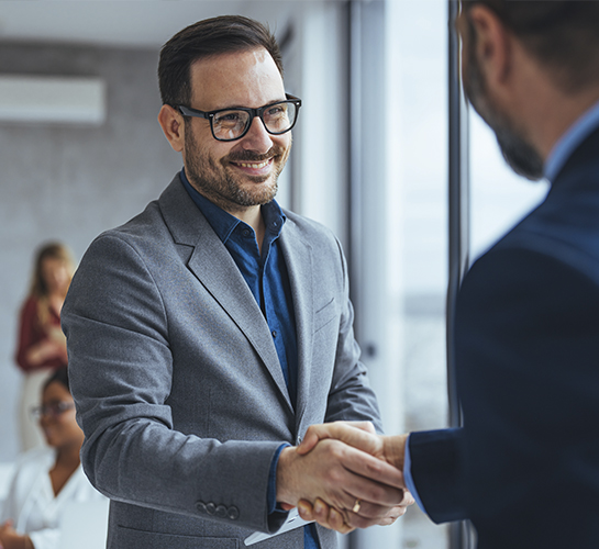 2 men in suits shaking hands