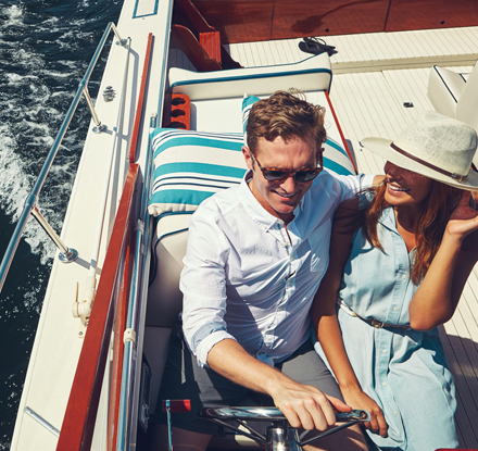 happy couple on a speed boat