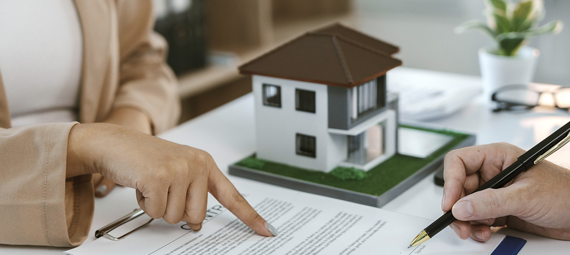 finger pointing to something on a contract 