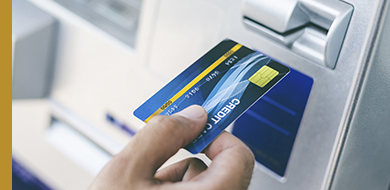 hand inserting a card into an atm machine